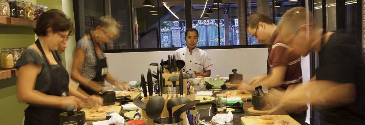 Guests learning to cook Khmer food together at a cooking class in Phnom Penh, Cambodia