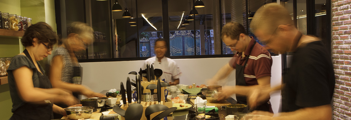 Students plating Khmer dishes with the chef during a Phnom Penh cooking class